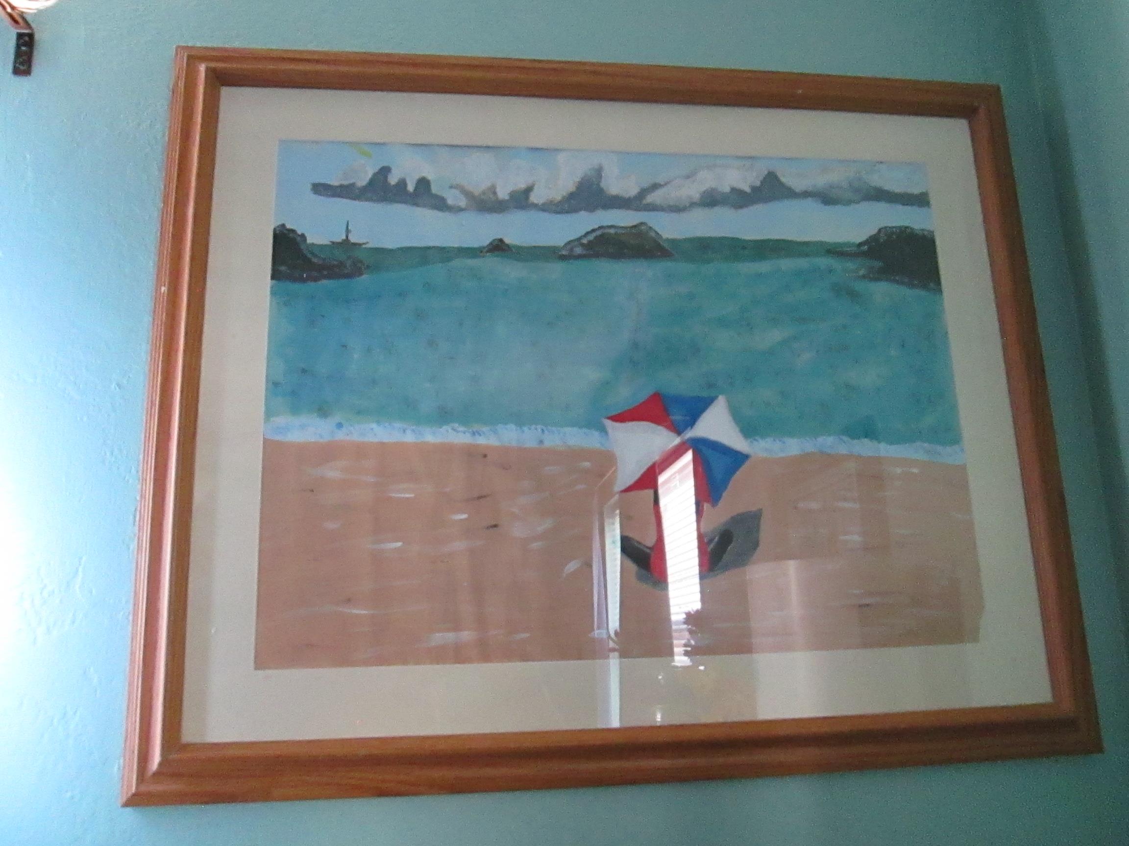 Colorful umbrellas stand on the sandy shore by a tranquil ocean under a bright sky.