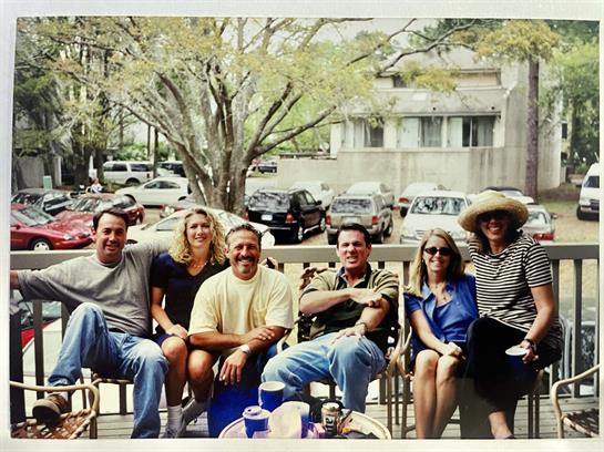 A group of people sitting on a porch