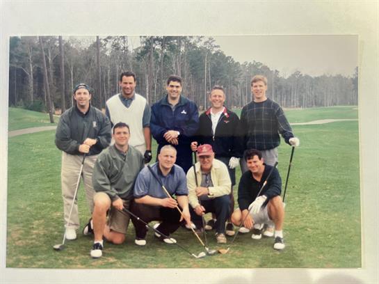 A group of men posing for a photo