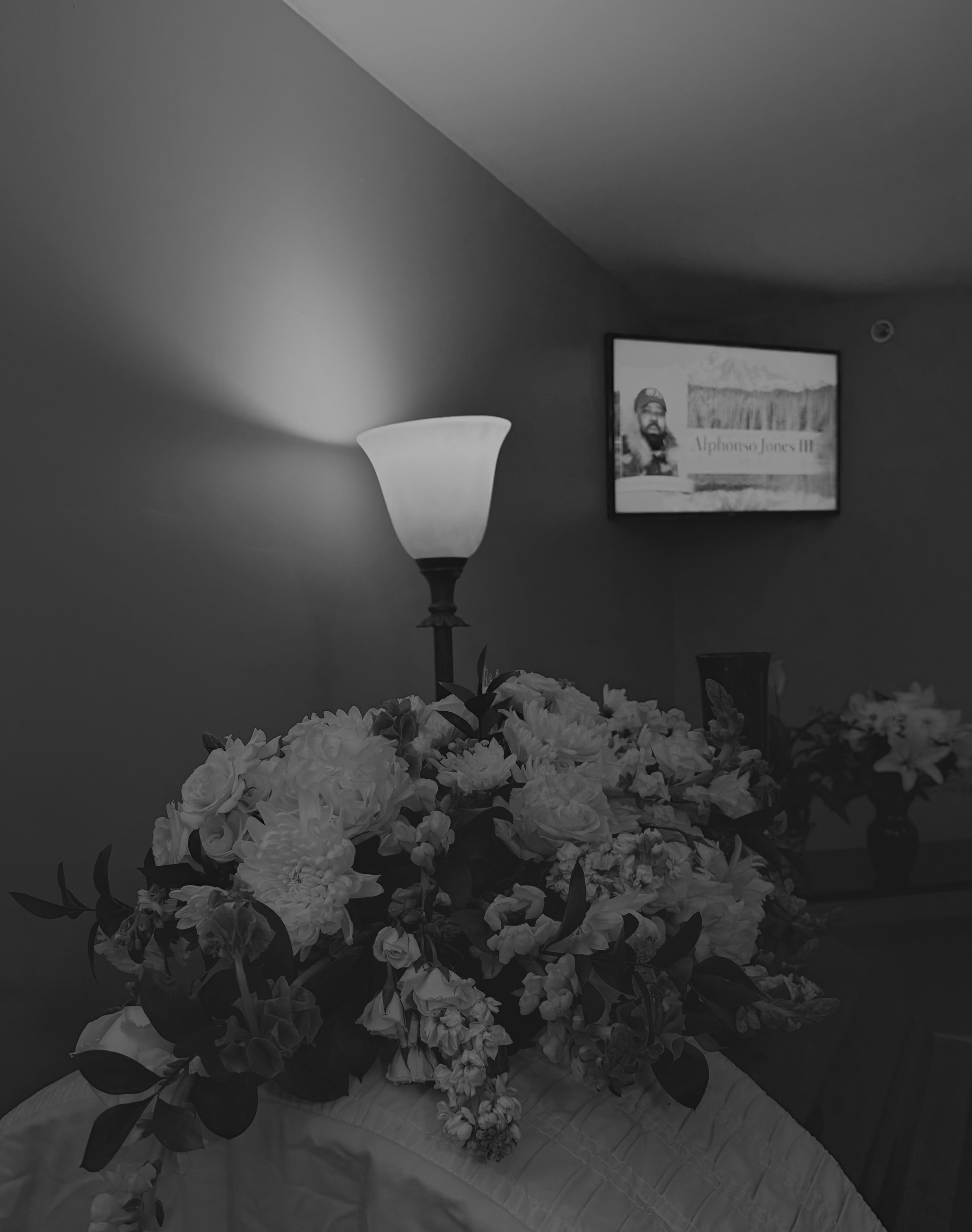 A lamp on a table with flowers