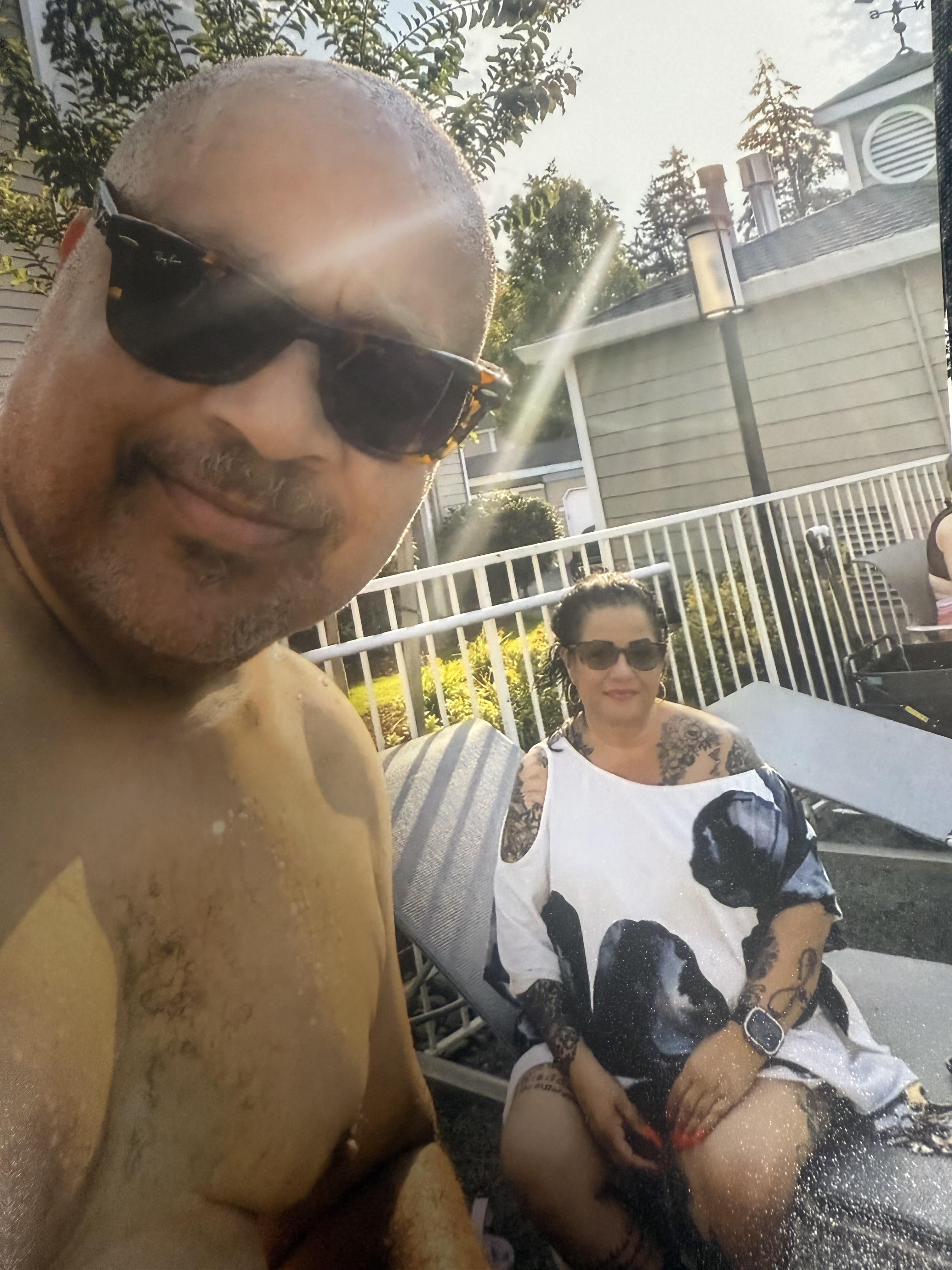 Friends relax by the pool on a sunny day, enjoying the warm weather and each other's company.