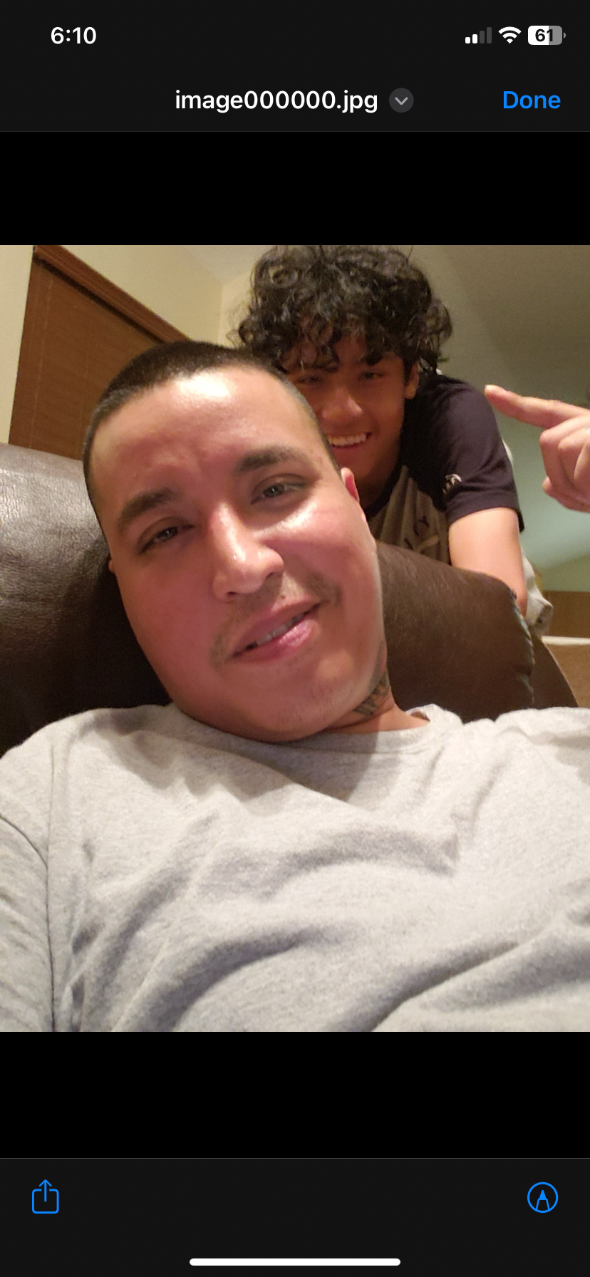 Friends pose together with smiles, showcasing a fun atmosphere and camaraderie at home.