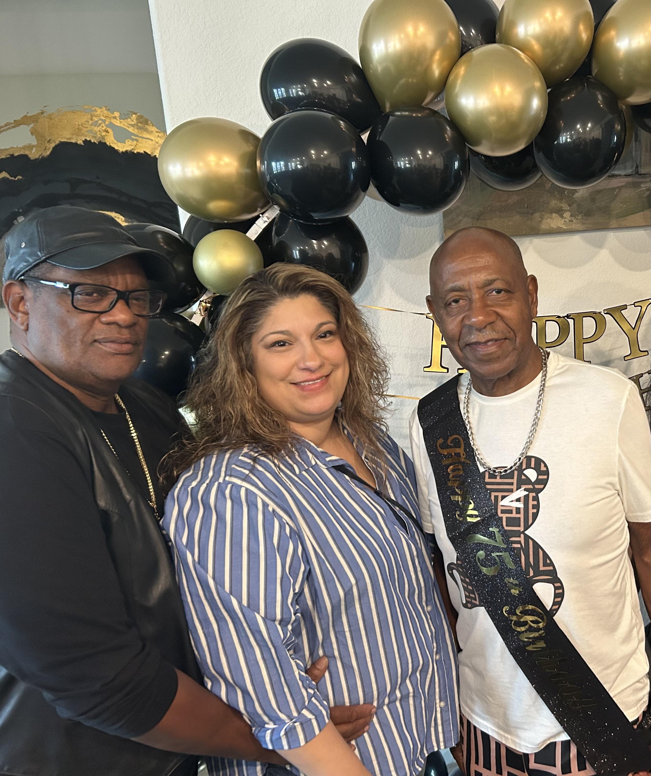 Friends gather to celebrate a birthday with balloons and a festive atmosphere filled with joy.