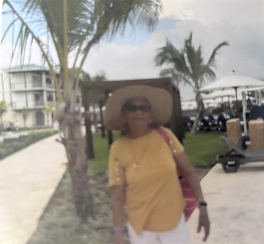 A woman wearing a hat and sunglasses
