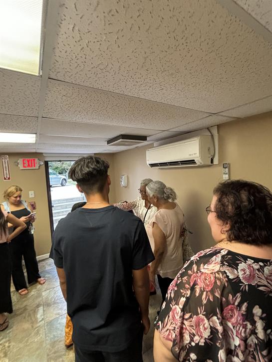 A group of people standing in a hallway