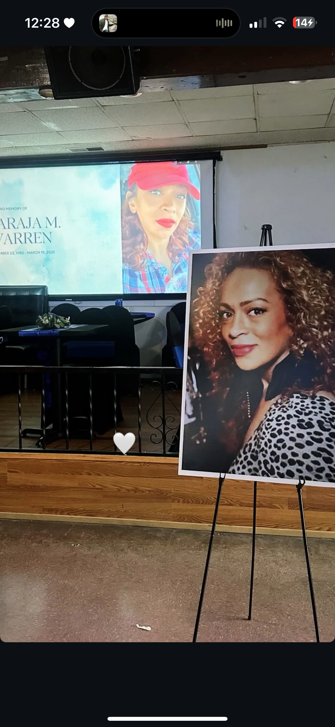 A tribute display for Naraja M Warren at a community event filled with warmth and memories.