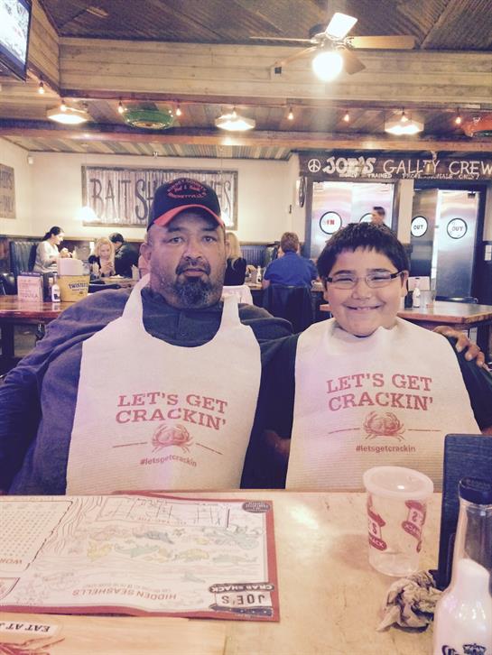 A man and boy wearing aprons