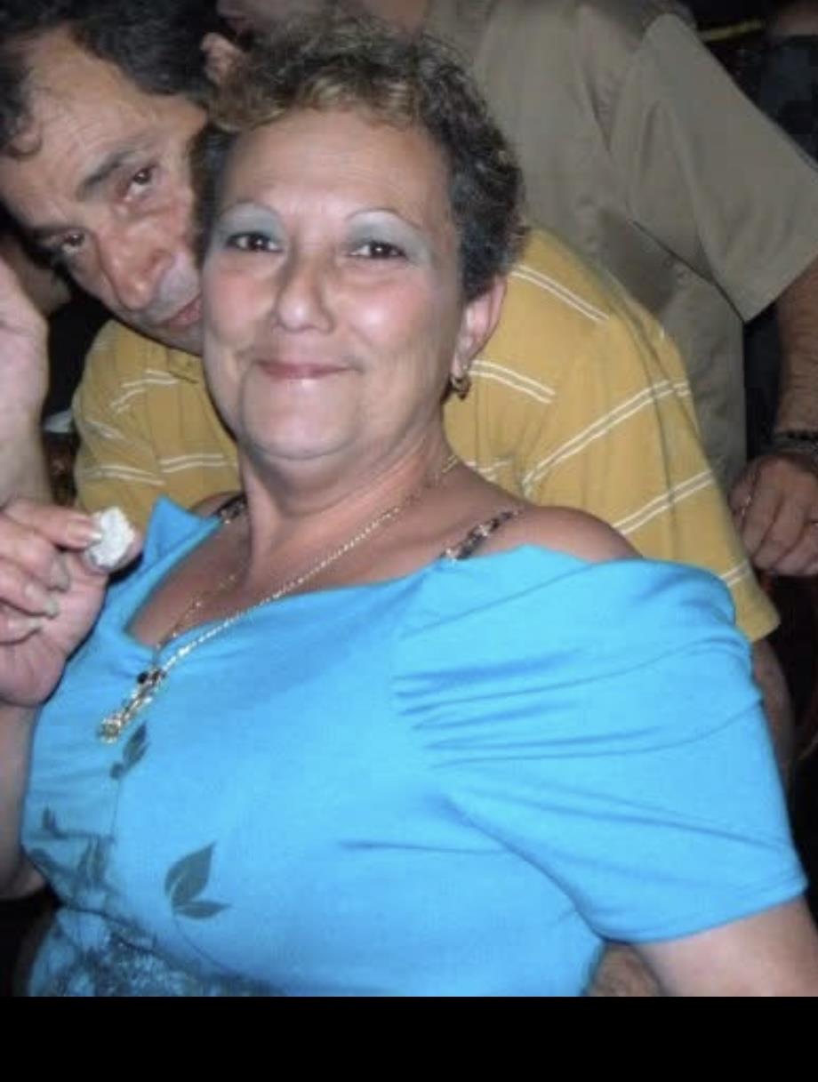 Two individuals enjoy a festive atmosphere, laughing and mingling at a social event with friends.