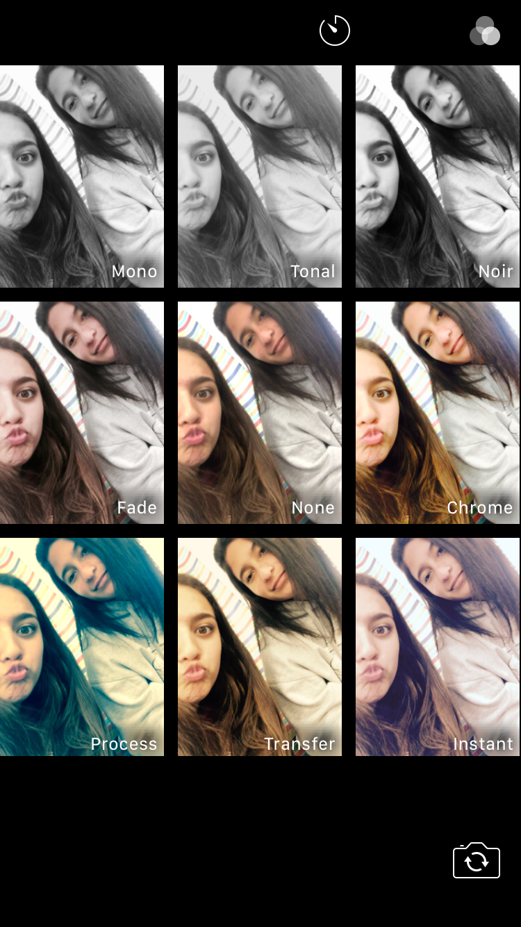 Two friends are enjoying a fun moment while trying out various photo effects at home.