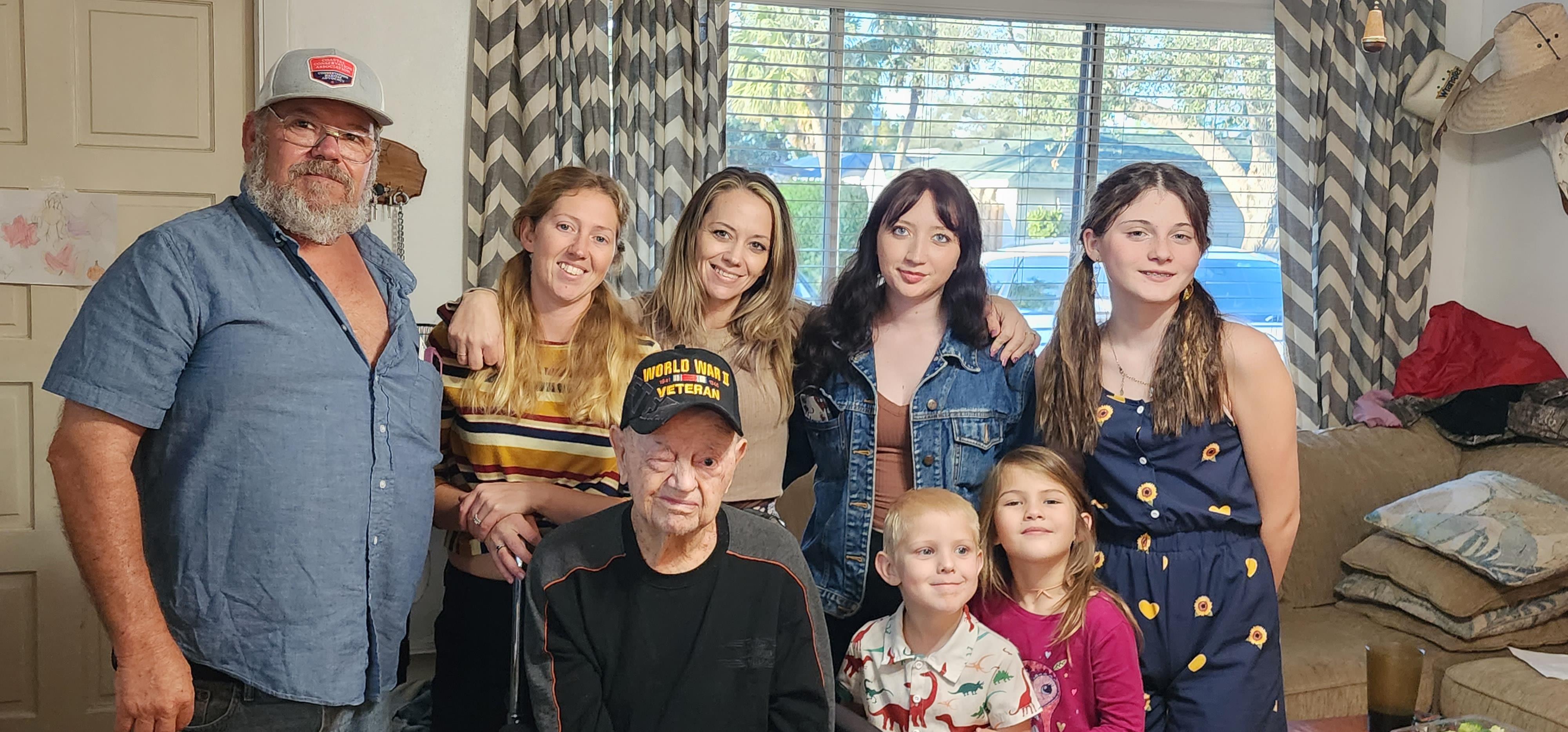 A family enjoys a joyful reunion in a warm living room filled with love and laughter.