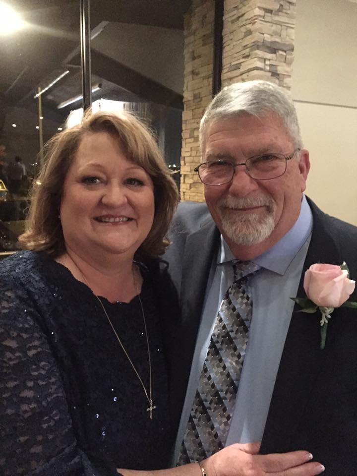 Couple enjoys a joyful moment together at a restaurant during a special celebration.