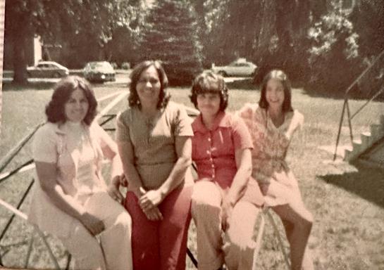 A group of women sitting on a bench