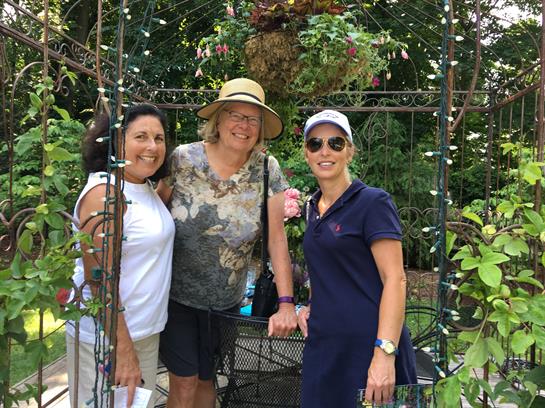 A group of women standing in a garden