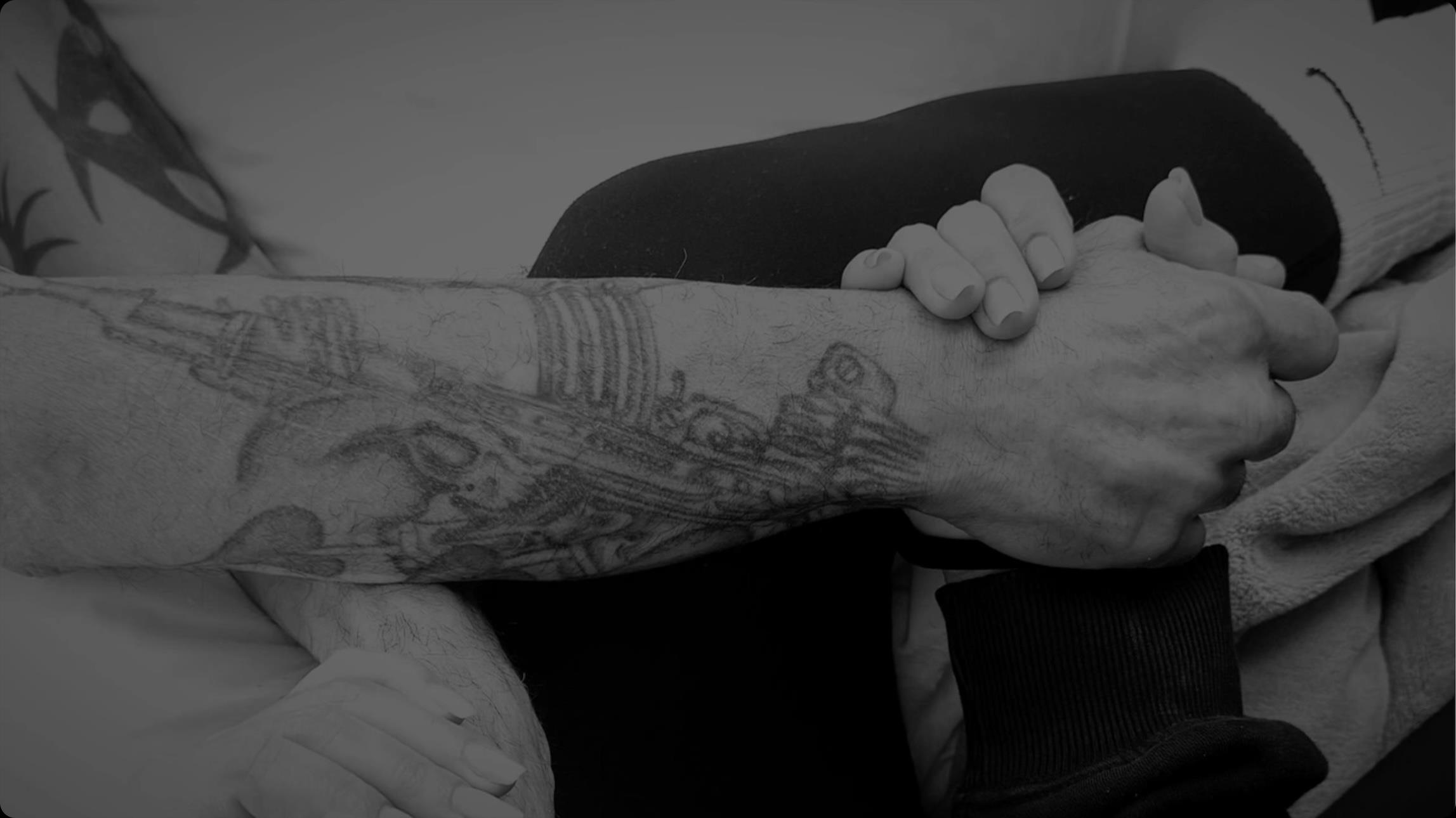 Two hands clasped together in a tender gesture, showcasing a bond of affection and trust.