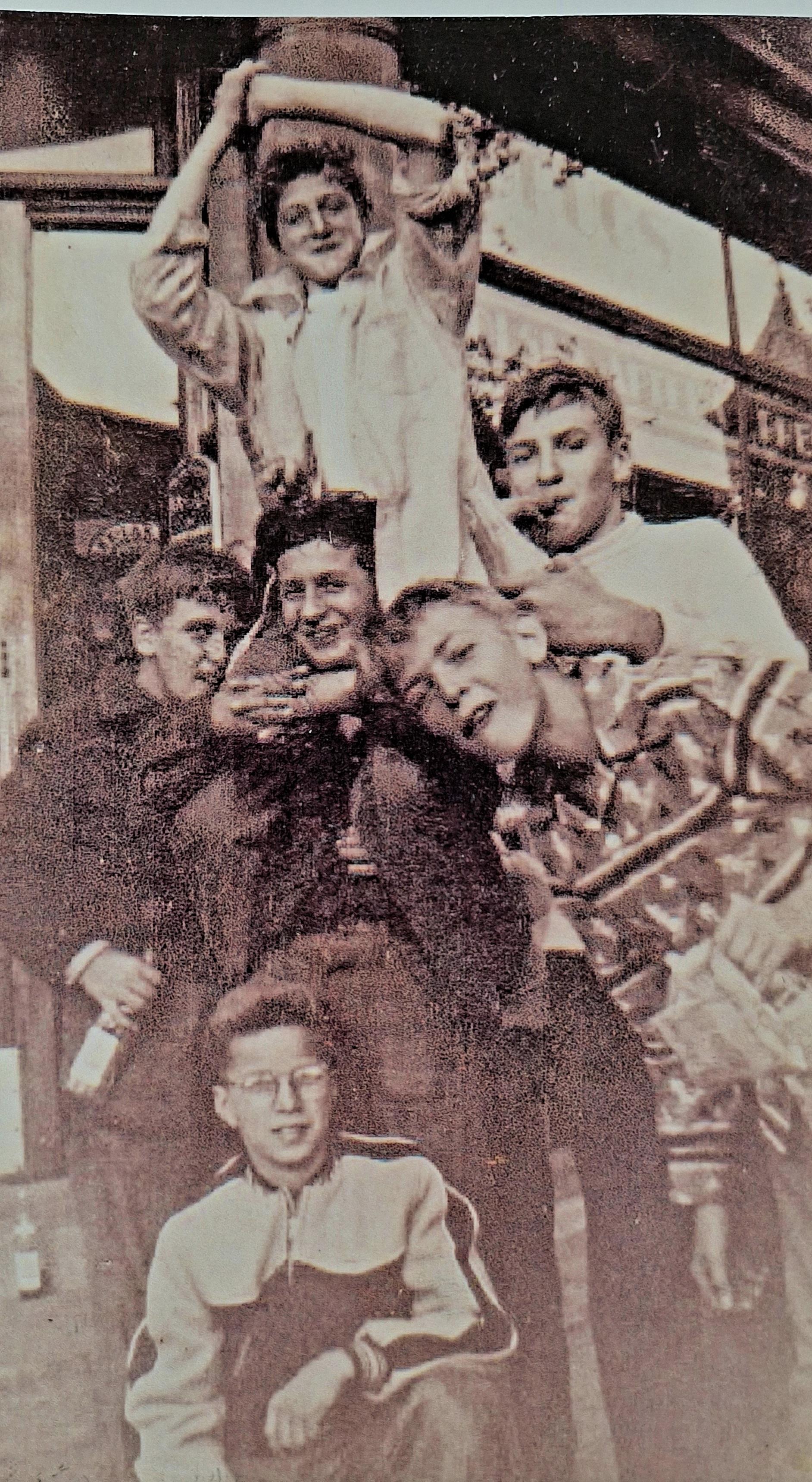 A group of young boys plays joyfully outside, enjoying their time together.