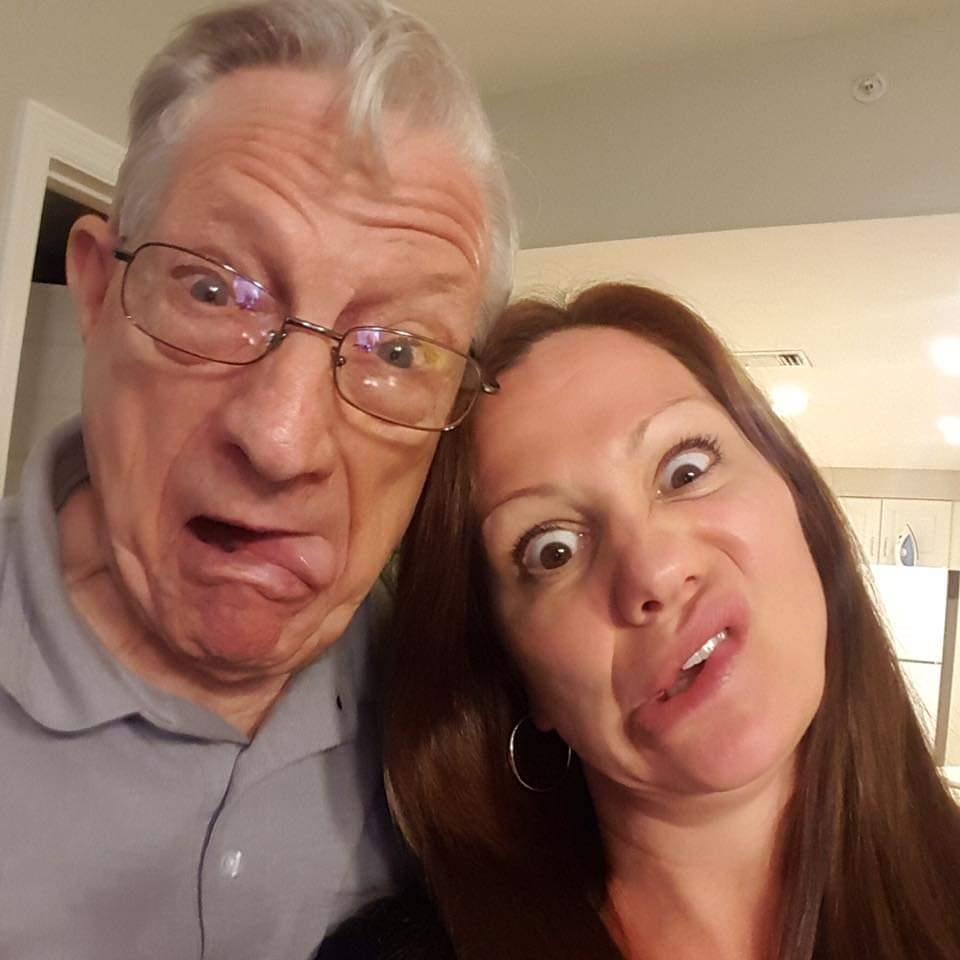 Two family members express humor by making funny faces and enjoying each other's company indoors.