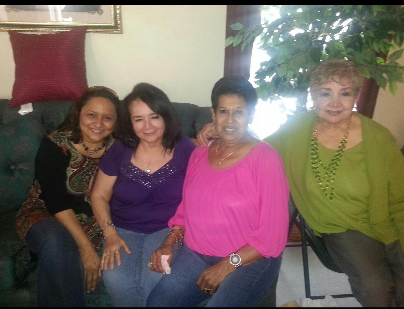 Four friends enjoy a relaxed afternoon together in a comfortable living room, sharing laughter.