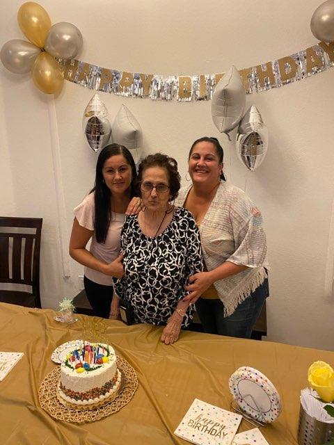 Family comes together to celebrate grandma's birthday with cake and cozy decorations.