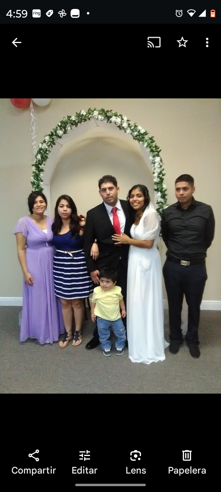 A family stands together in formal attire, celebrating a wedding with love and happiness.