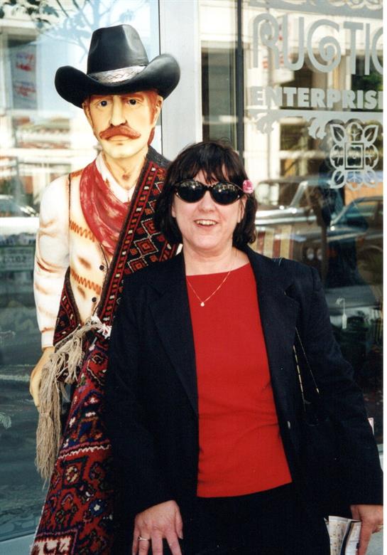 A woman standing next to a statue