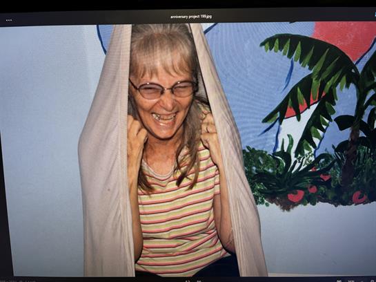 A woman smiling in a curtain