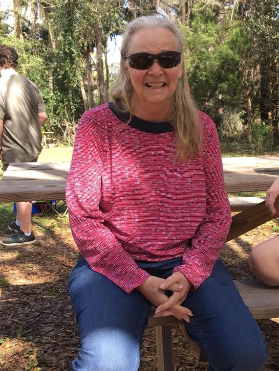 A woman sitting on a picnic table