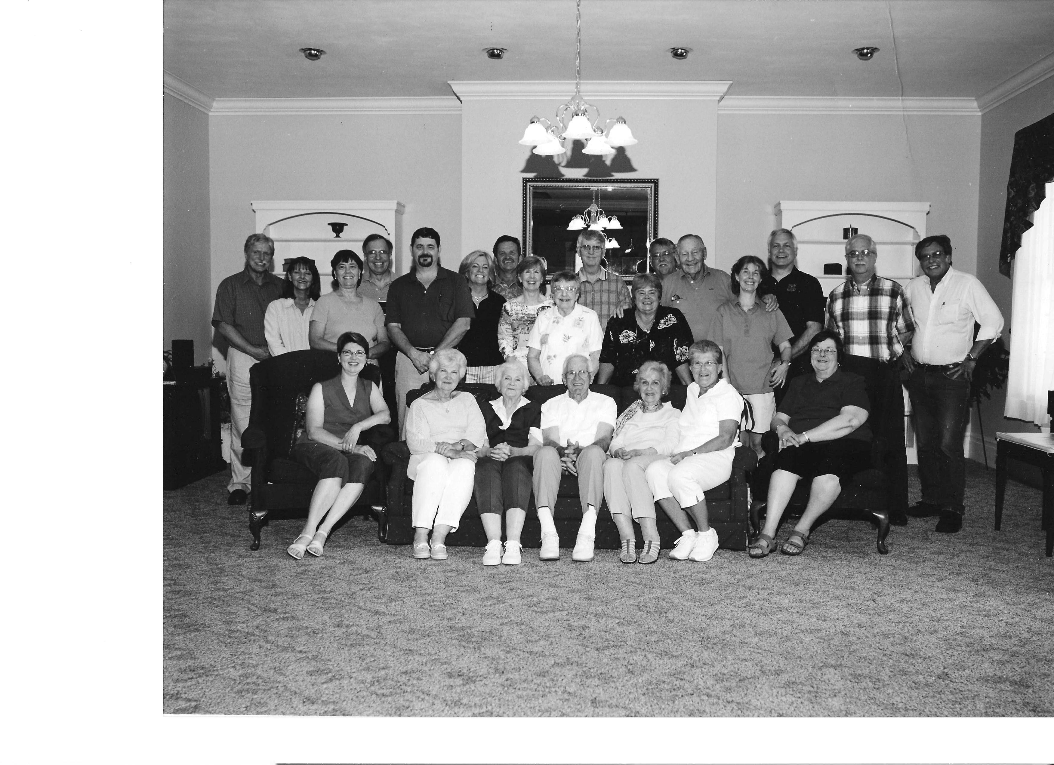 Friends and family gather in a cozy living room, sharing laughs and memories on a sunny day.