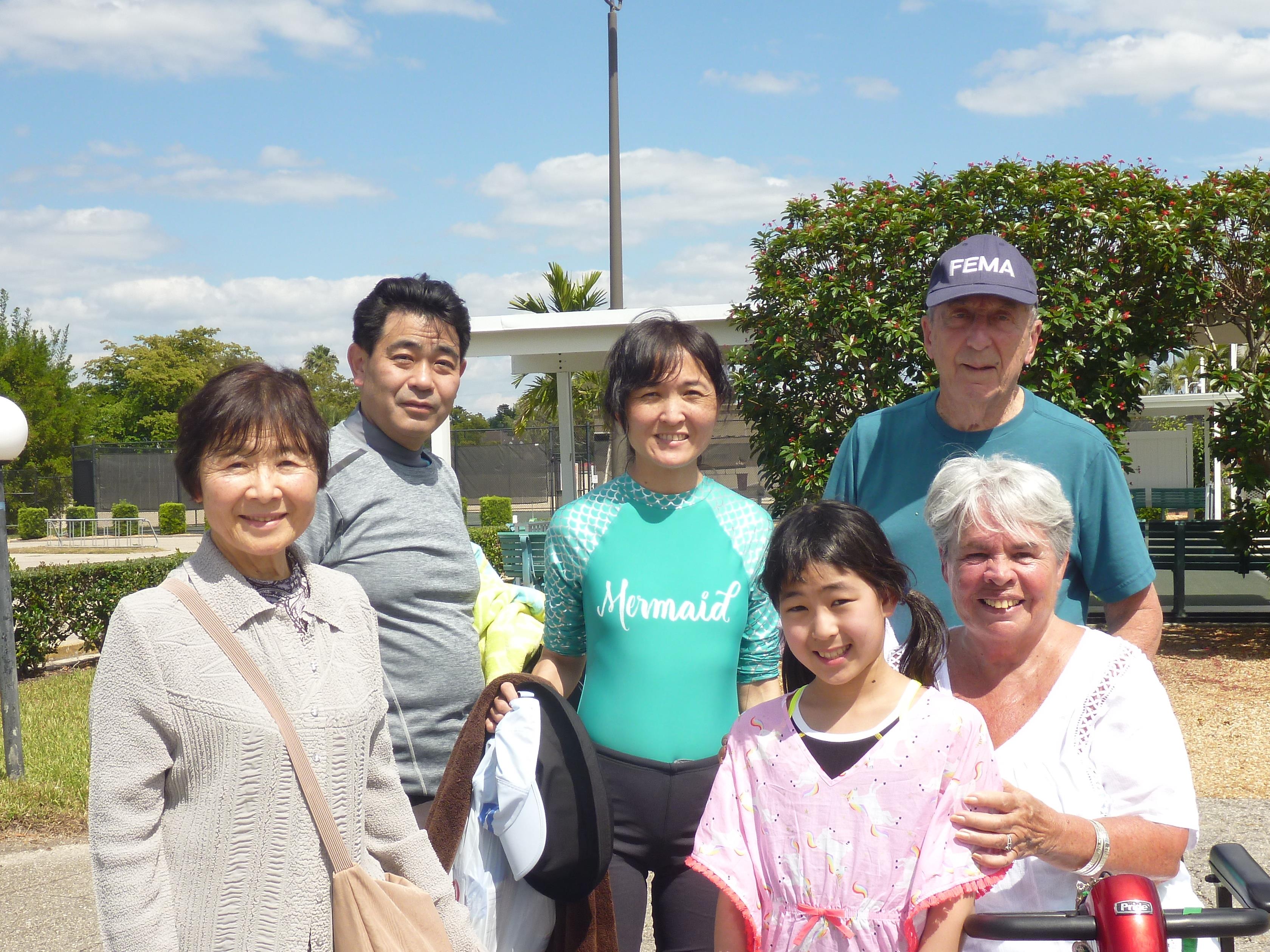People gather for a joyful family outing at the park with bright skies and smiles all around.