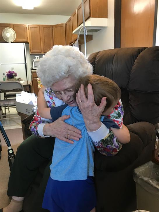 An old woman holding a young boy
