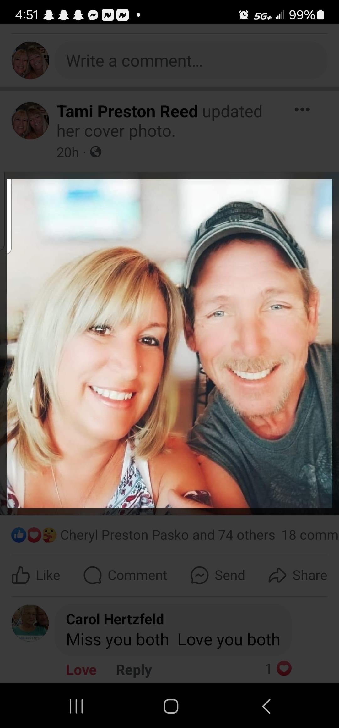 A joyful couple smiles in a bright, relaxed location, capturing a moment of togetherness outdoors.