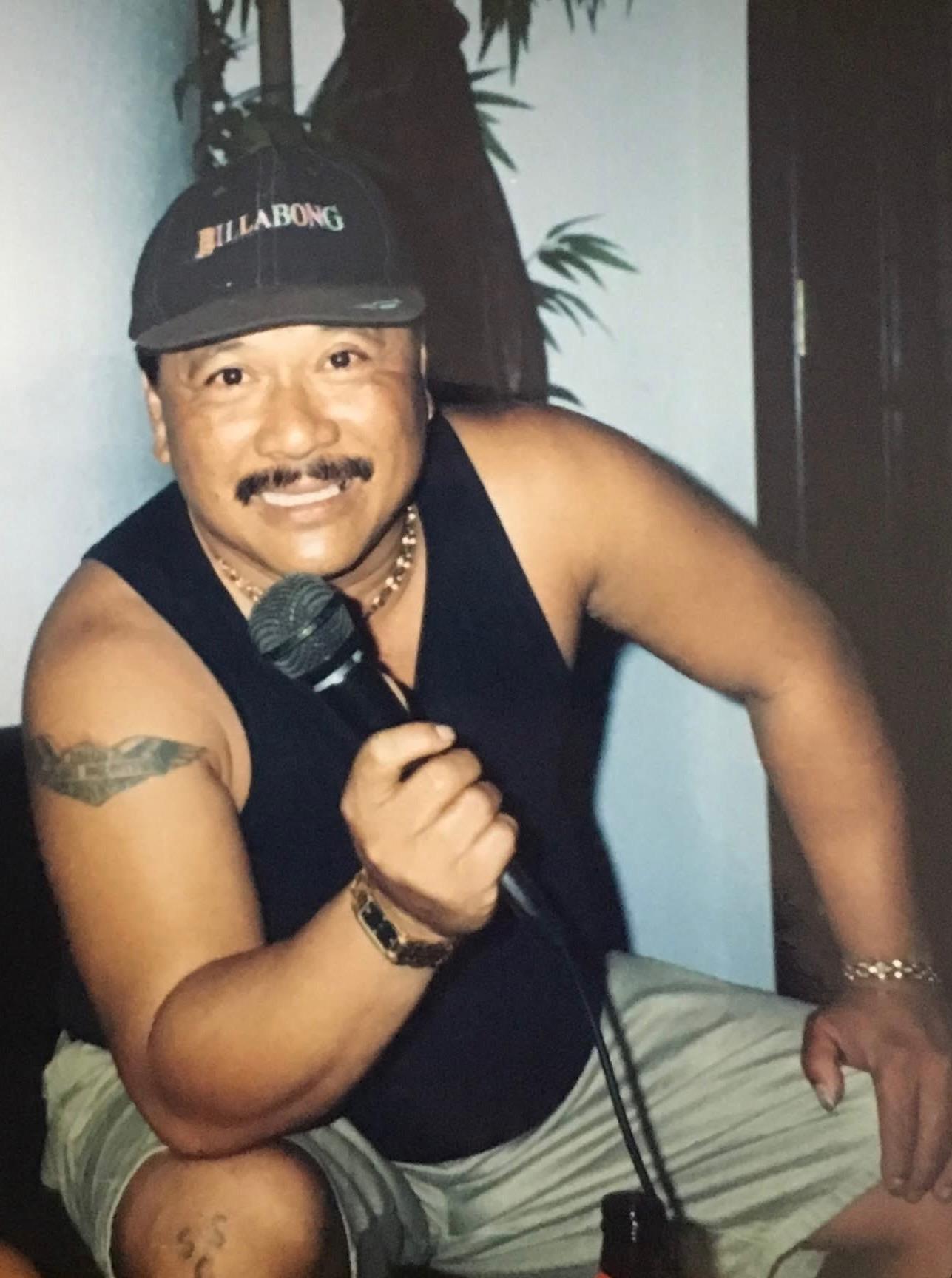 A cheerful man with a microphone highlights the joyous spirit of karaoke night.