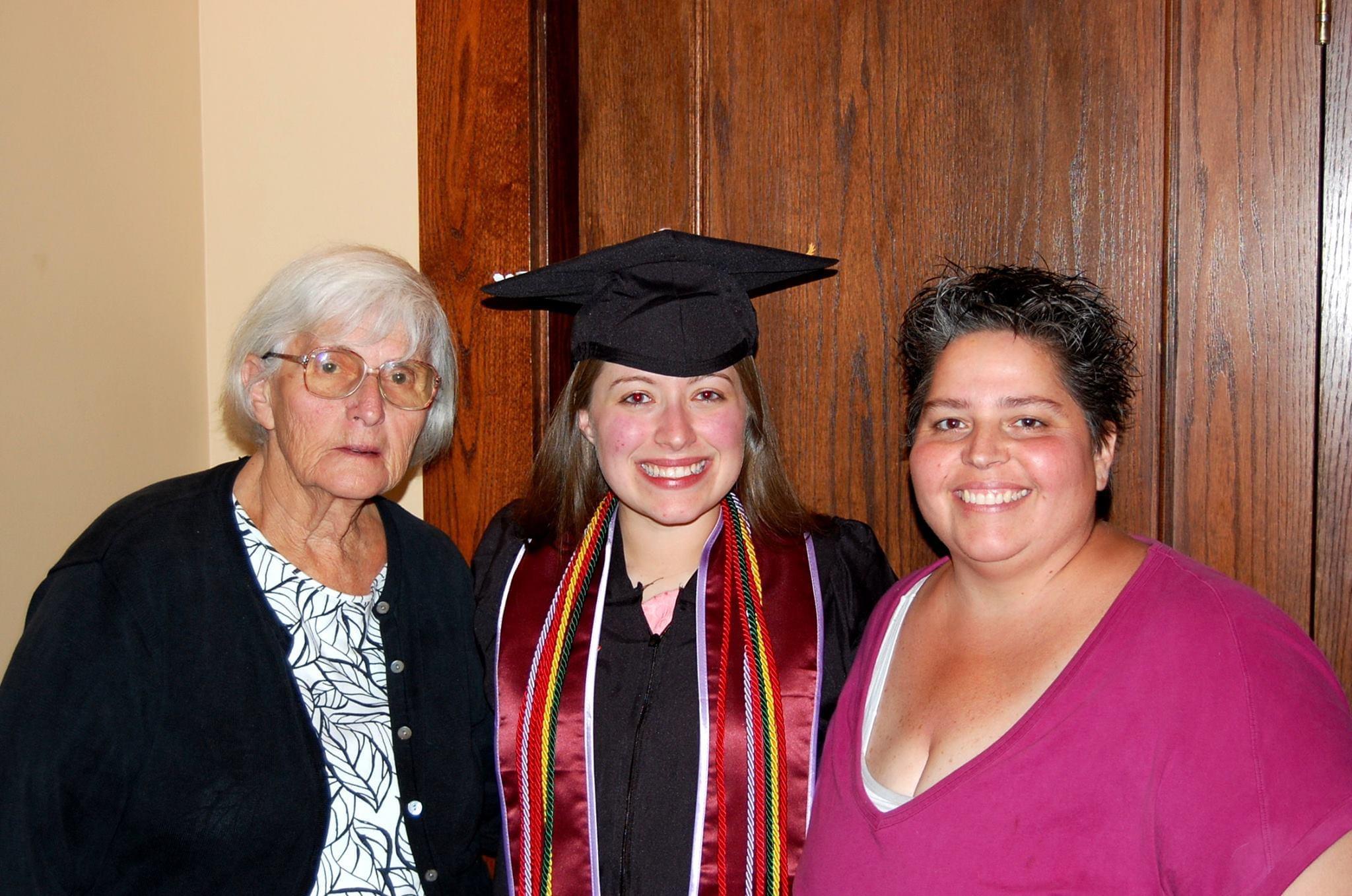 Family members gather to celebrate a graduation milestone in a cozy indoor setting.