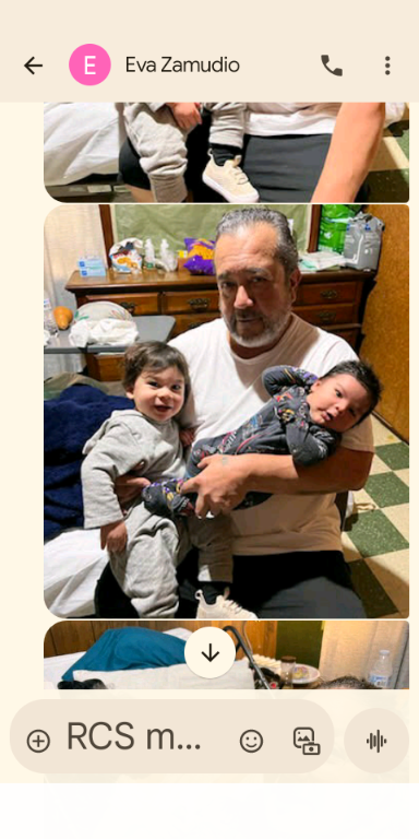 A loving grandfather enjoys precious moments with his two grandchildren on a cozy evening.