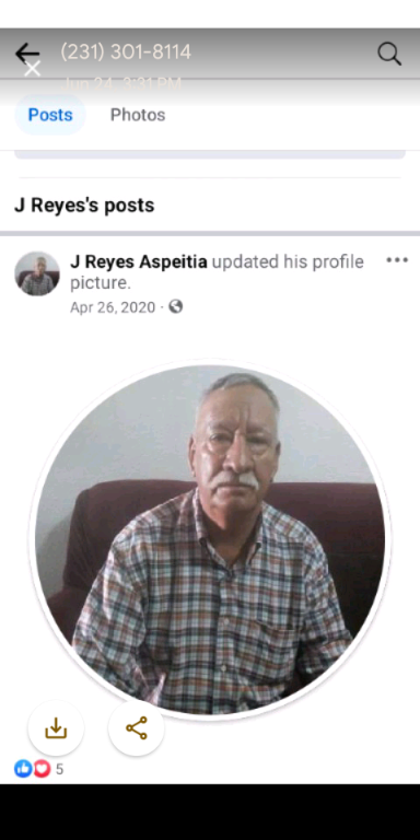 An elderly man is seen smiling while updating his profile picture from his living room.
