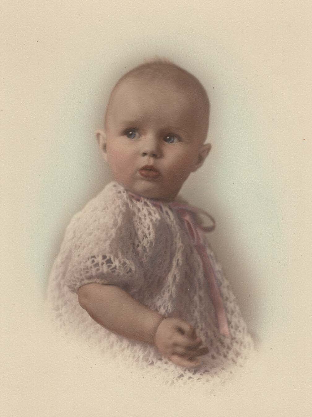 A baby wearing a pink dress