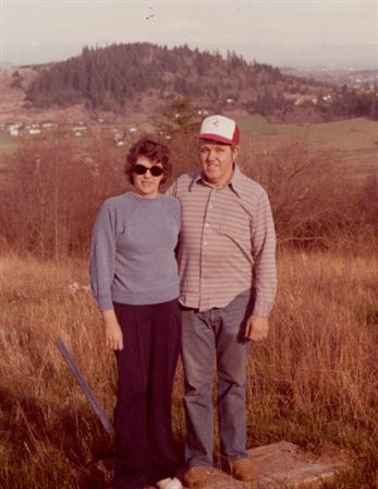 A man and woman standing in a field