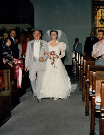 A man and woman walking down the aisle
