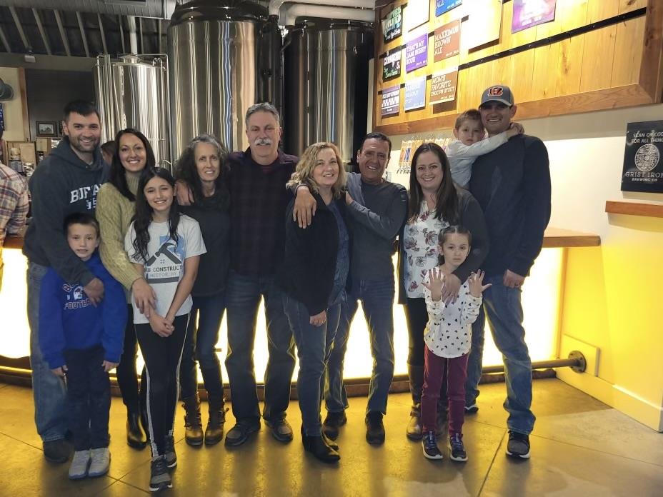 A lively family gathering inside a brewery, enjoying each other's company in winter.
