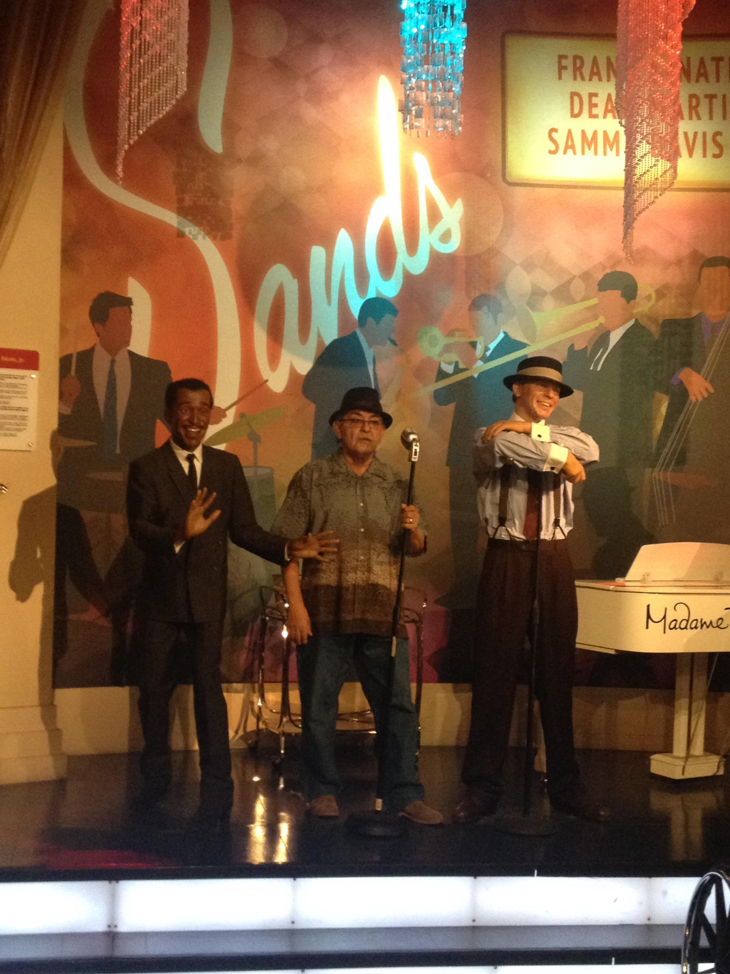 Three performers showcase their talent in a lively jazz club decorated with colorful lights.