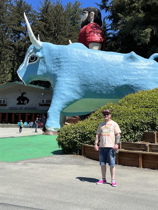 A man standing in front of a statue of a bull