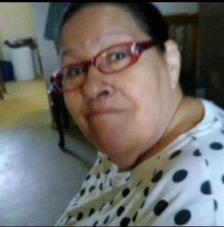A woman wearing glasses and a polka dot shirt