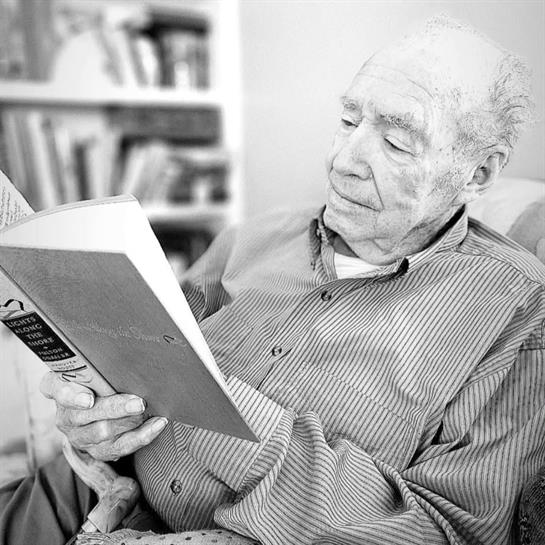 An old man reading a book