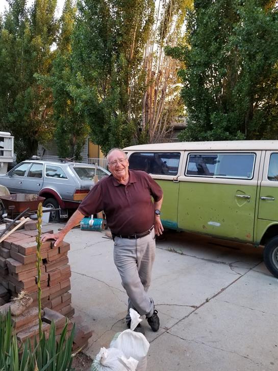 A man leaning on a stack of bricks