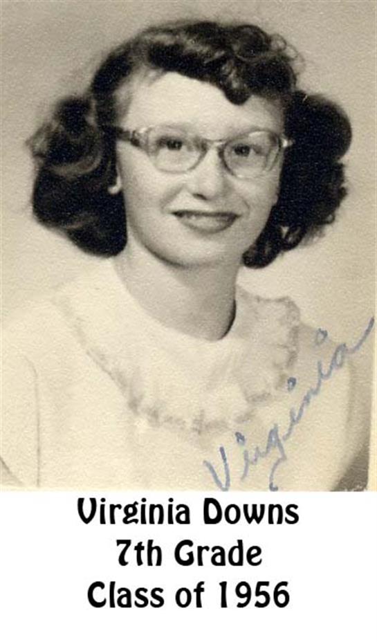 A woman wearing glasses and smiling