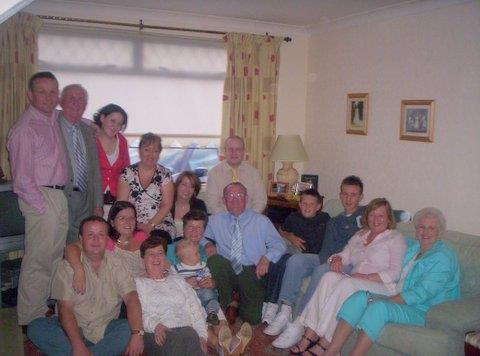 A happy family gathers in a cozy living room, sharing laughter on a sunny afternoon.