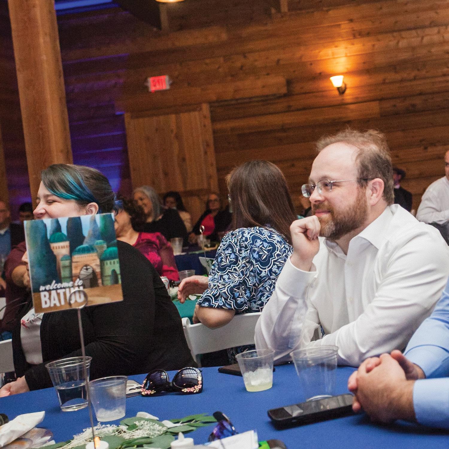 Attendees engage in conversations while surrounded by cheerful decorations and warm ambiance.