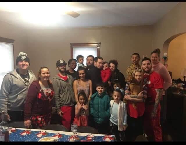 Group of family and friends enjoy a joyful holiday gathering in a warm living room.