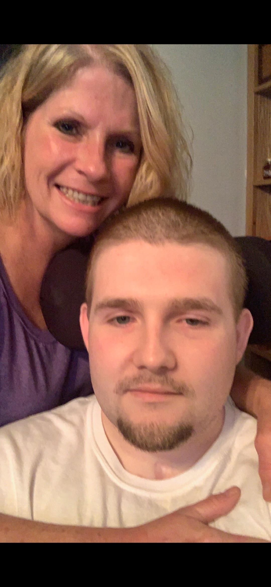 A woman and a man enjoy a lighthearted moment at home, sharing smiles and warmth.