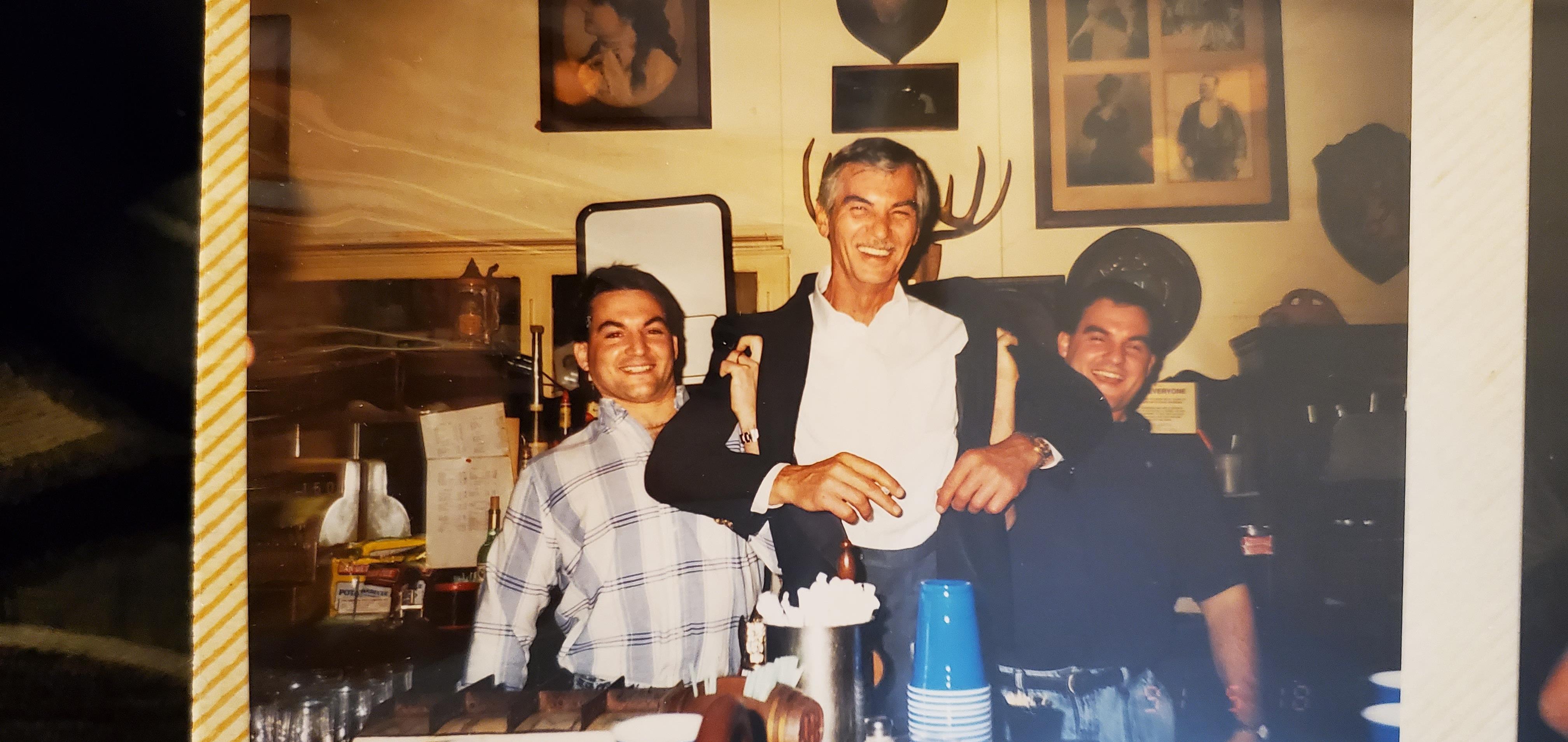 Friends enjoy a joyful moment at a bar, sharing laughter and drinks in an inviting atmosphere.