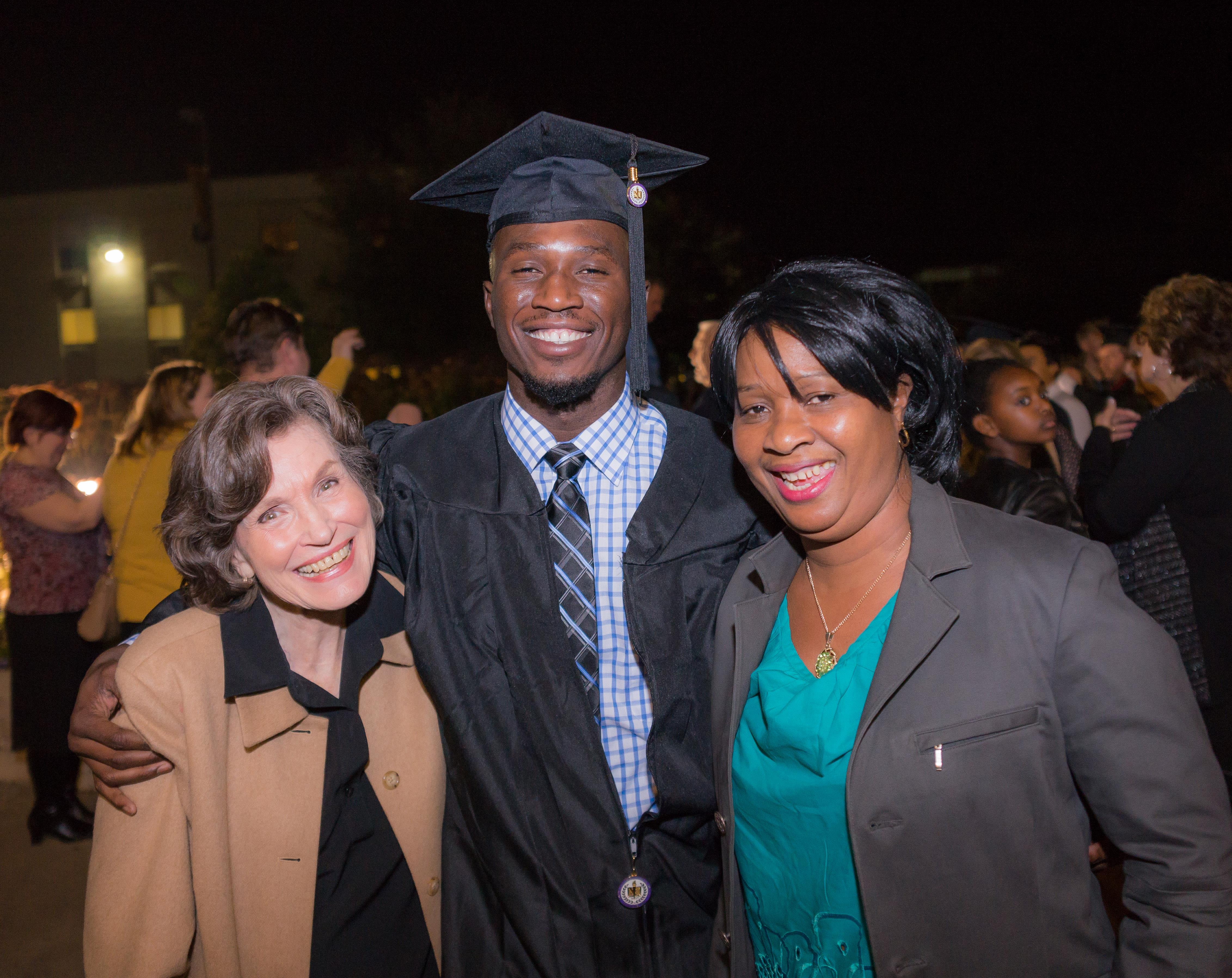 Family members celebrate a graduate's achievement at nighttime, filled with joy and pride.